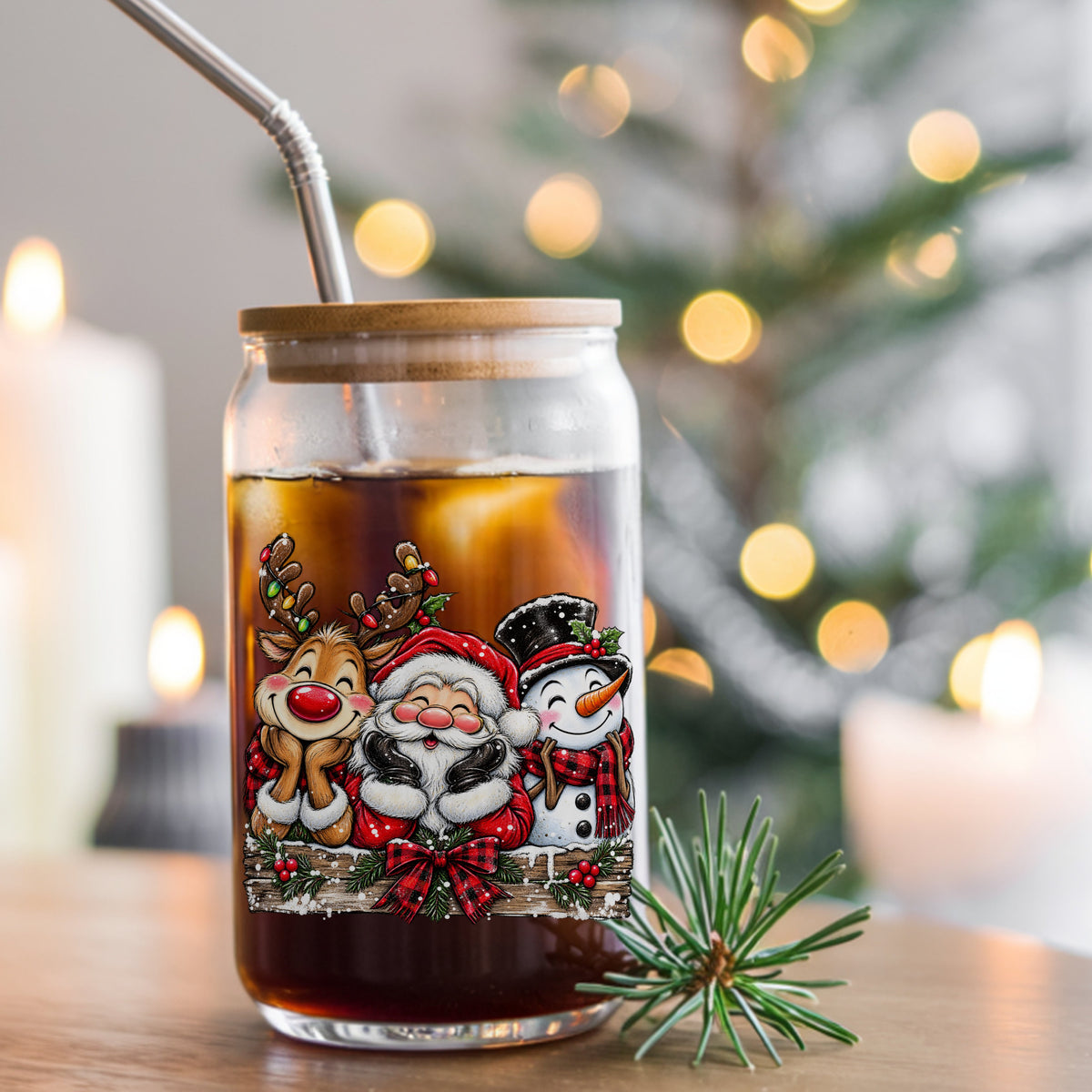 Santa Reindeer Snowman Plaid Bow UV DTF sticker applied to a glass can cup of iced coffee with a straw