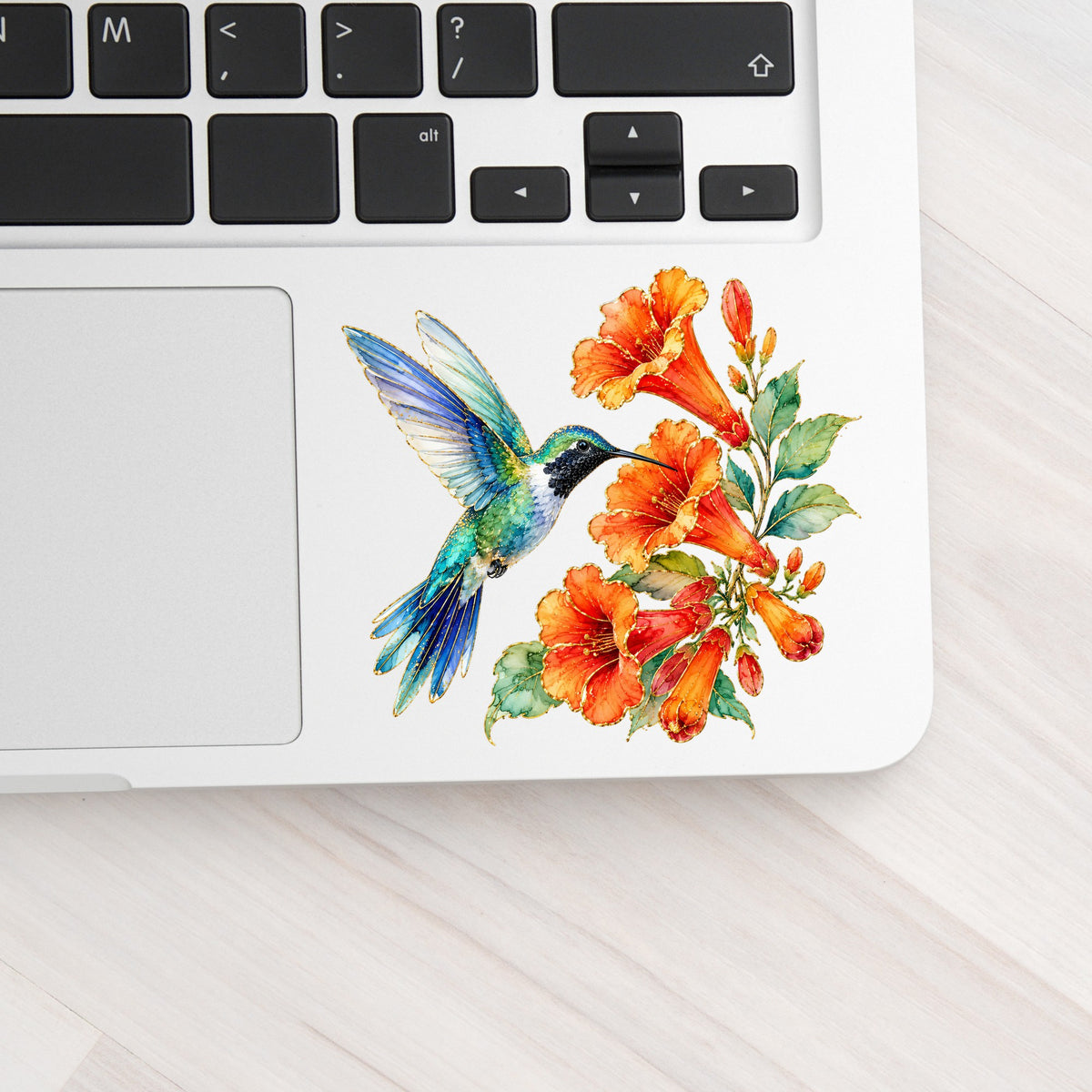 Blue Hummingbird Trumpet Flowers UV DTF sticker applied to a silver laptop beside the keyboard