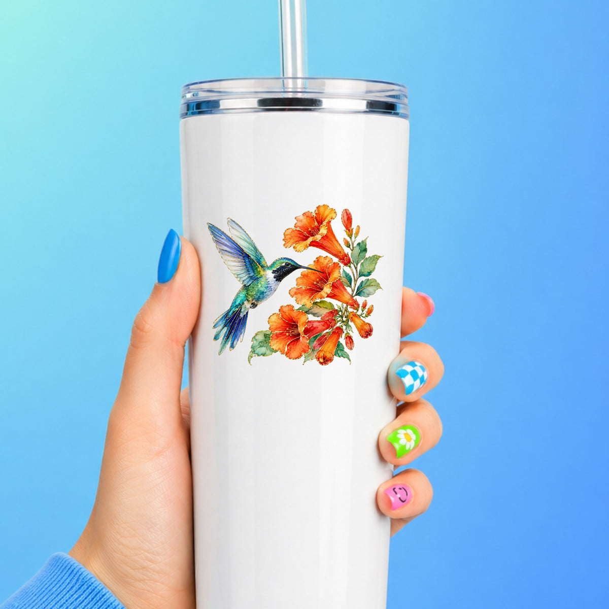 Blue Hummingbird Trumpet Flowers UV DTF sticker applied to a white straw tumbler on a blue background