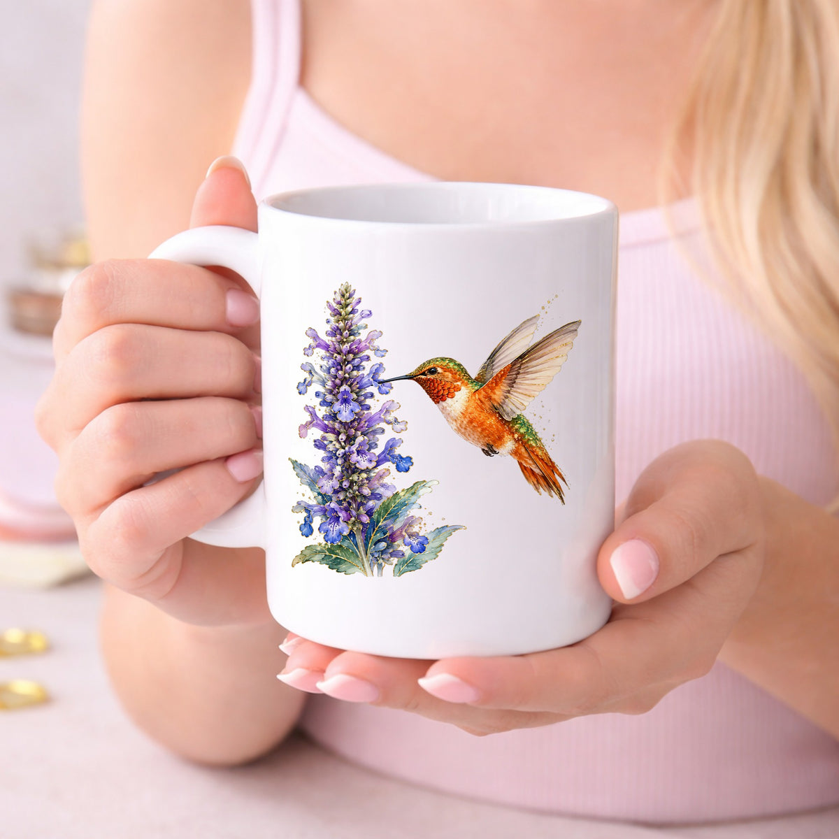 Rufous Hummingbird Purple Flowers UV DTF sticker applied to a white coffee mug held in both hands