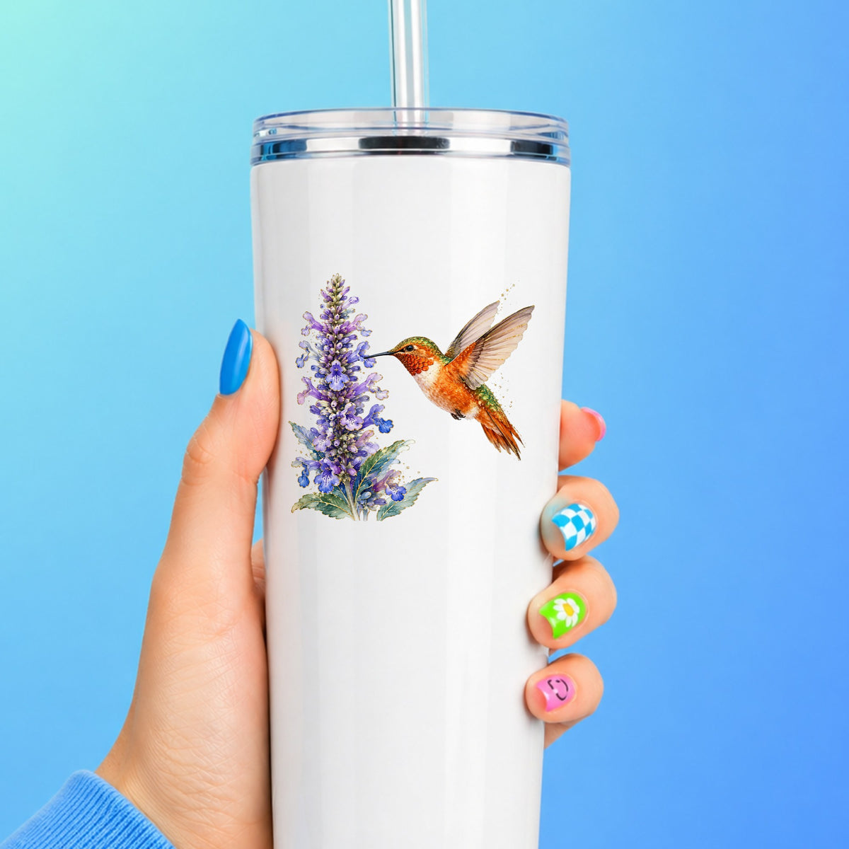 Rufous Hummingbird Purple Flowers UV DTF sticker applied to a white straw tumbler on a blue background