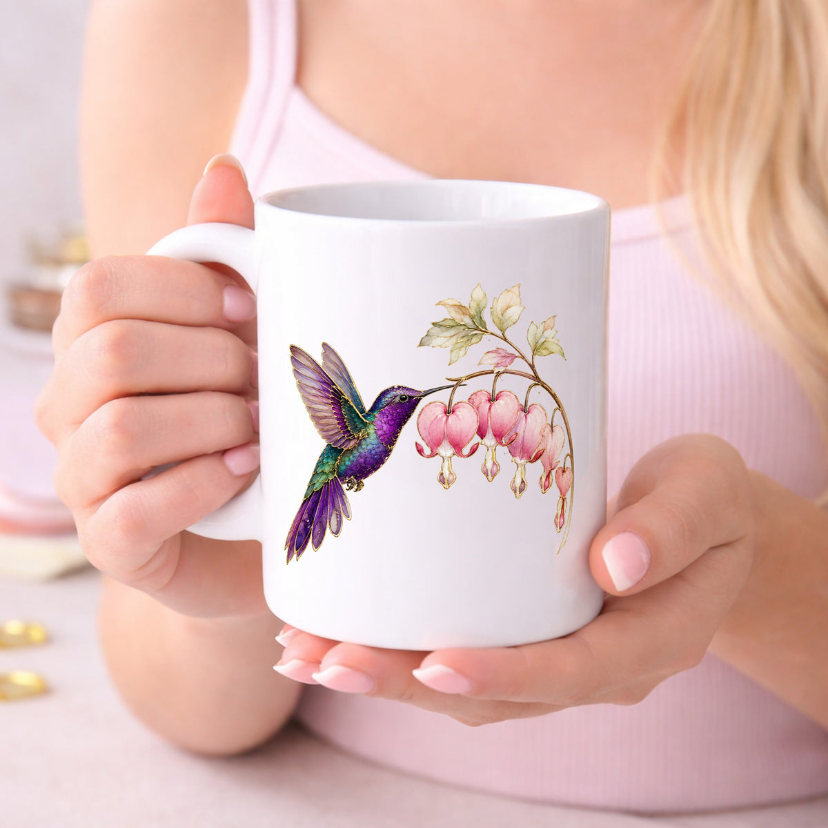 Purple Hummingbird Bleeding Heart UV DTF sticker applied to a white coffee mug held in both hands