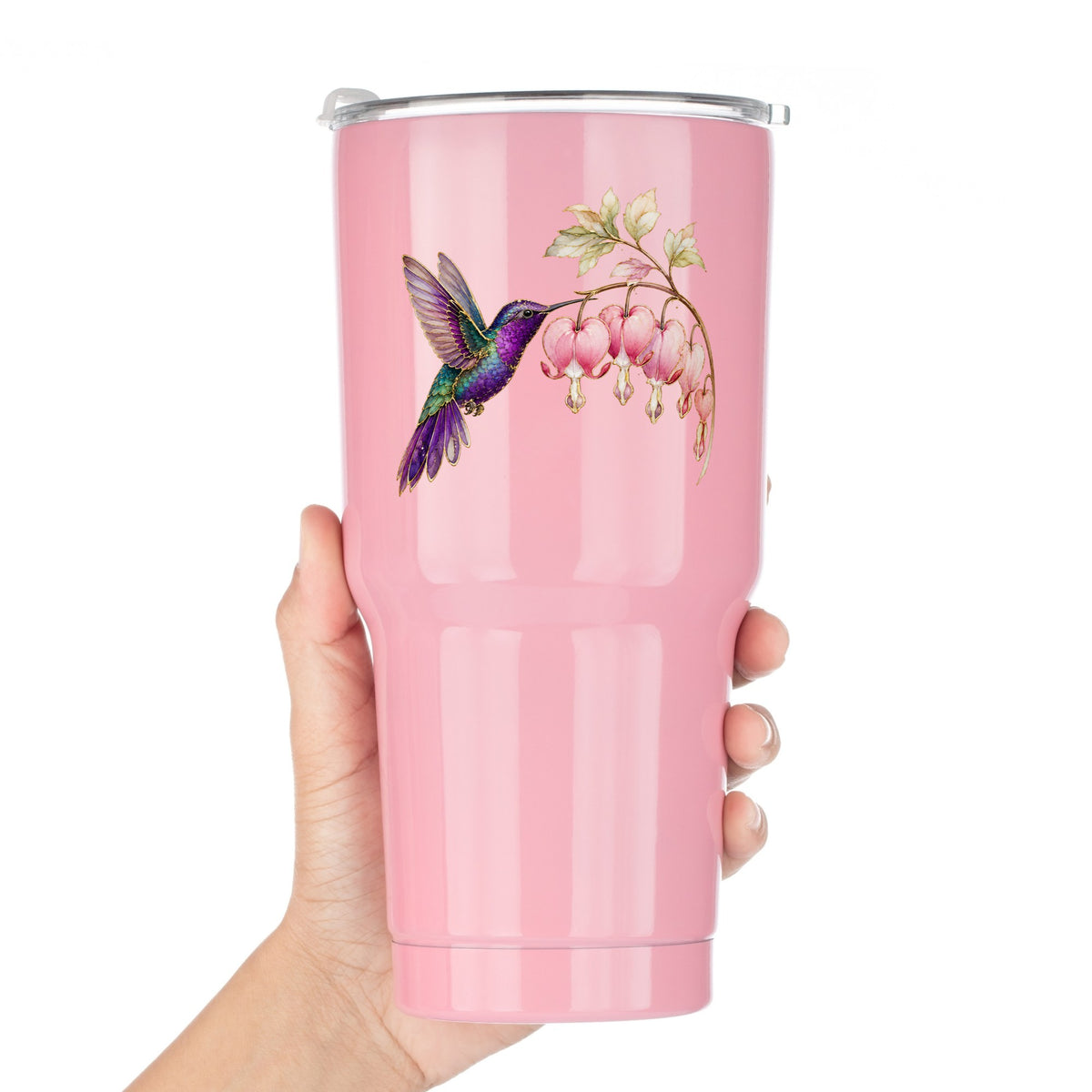 Purple Hummingbird Bleeding Heart UV DTF sticker applied to a pink tumbler held against a white background