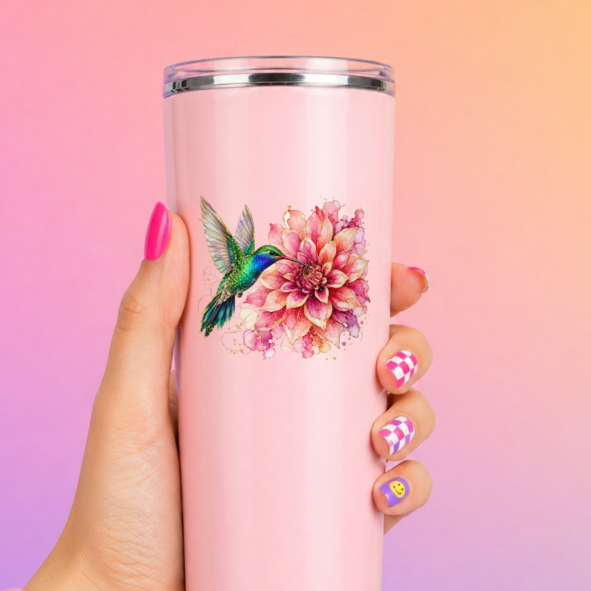 Hummingbird Pink Dahlia UV DTF sticker applied to a tall pink tumbler on a pink and orange background