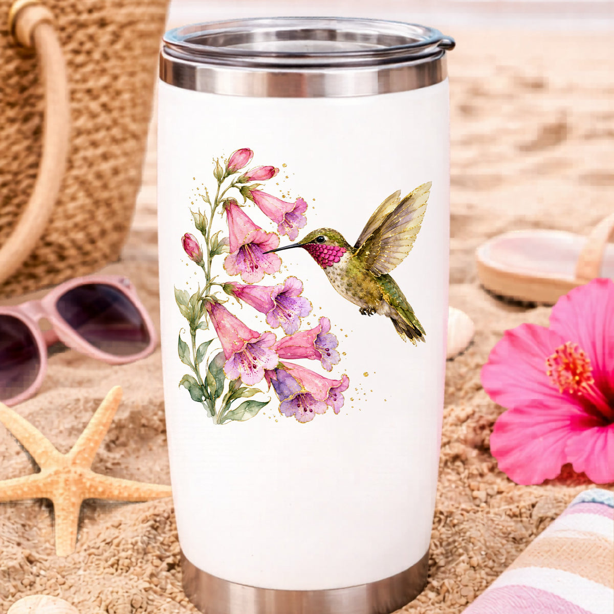 Ruby Throated Hummingbird Pink Bells UV DTF sticker applied to a white travel tumbler on beach sand