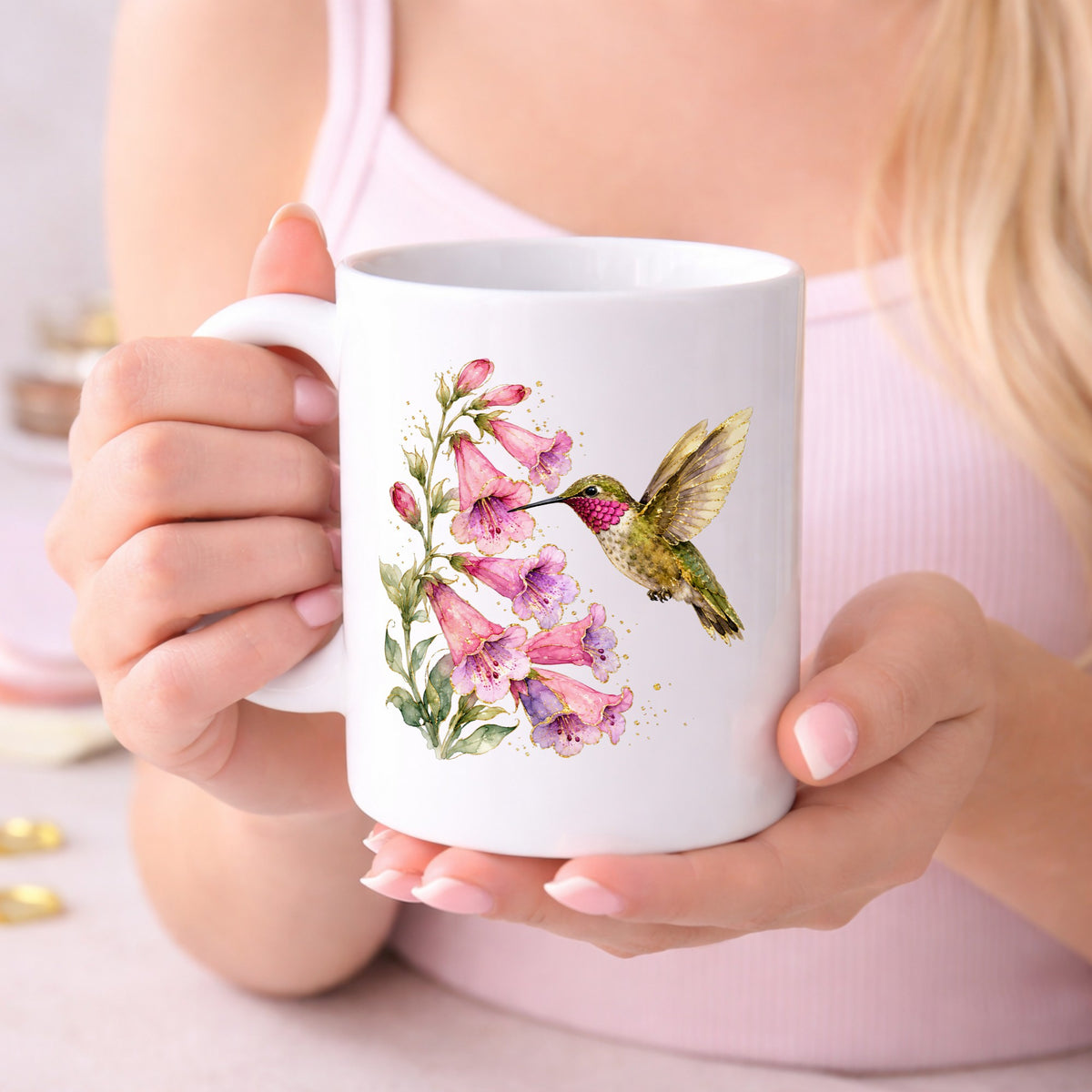 Ruby Throated Hummingbird Pink Bells UV DTF sticker applied to a white coffee mug held in both hands