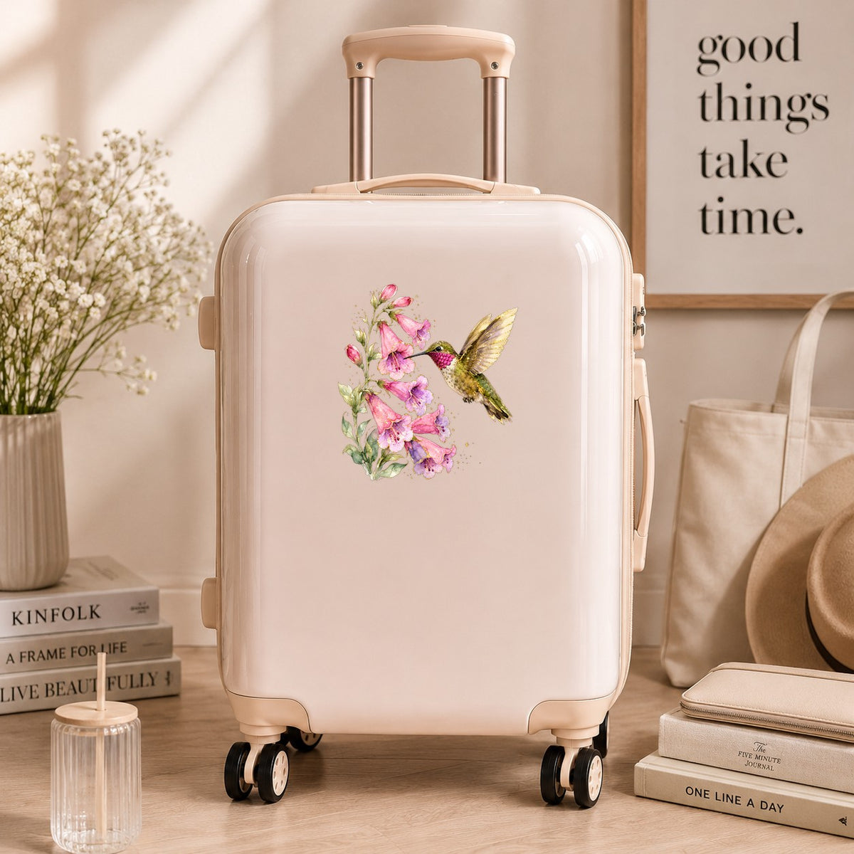 Ruby Throated Hummingbird Pink Bells UV DTF sticker applied to a cream carry-on suitcase