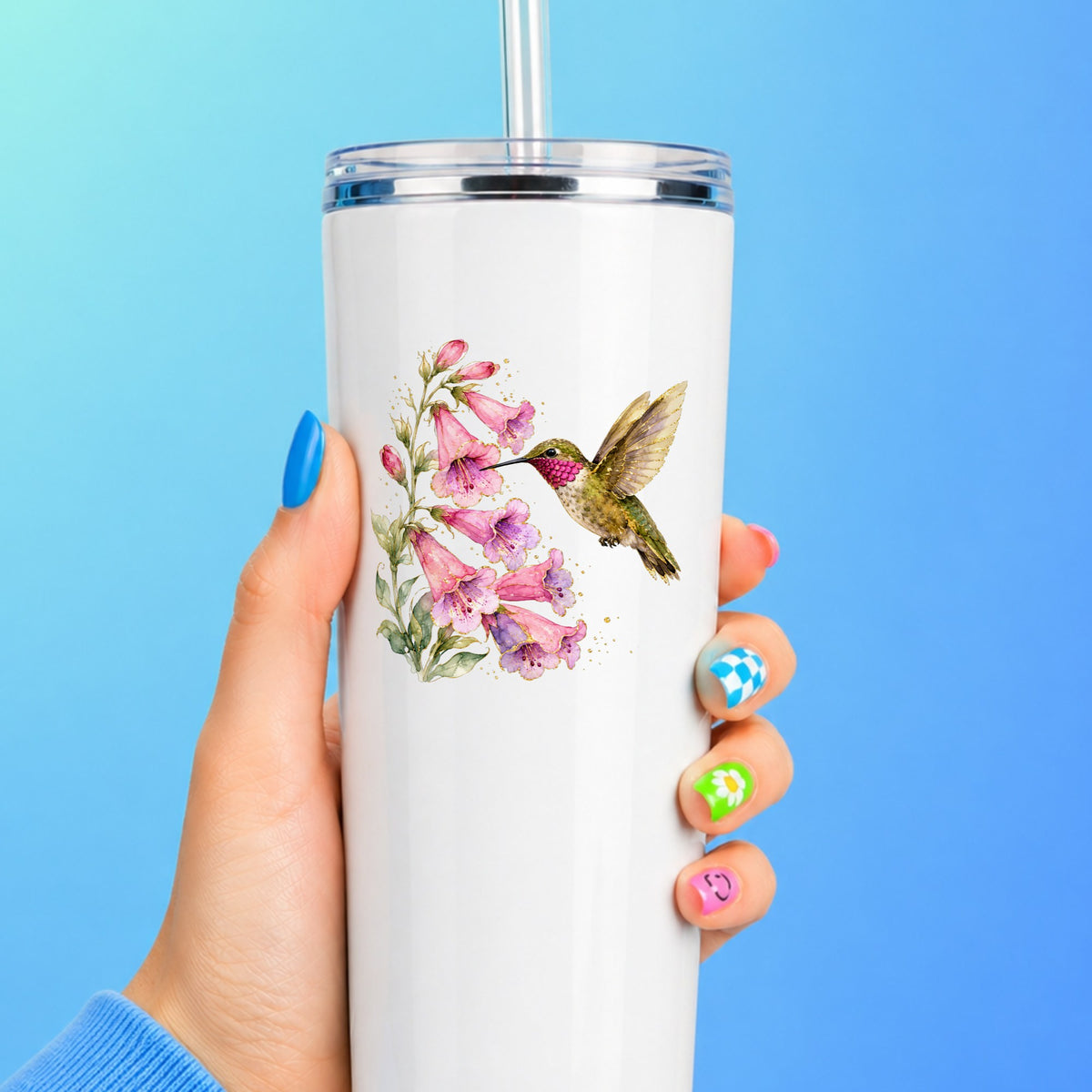 Ruby Throated Hummingbird Pink Bells UV DTF sticker applied to a white straw tumbler on a blue background