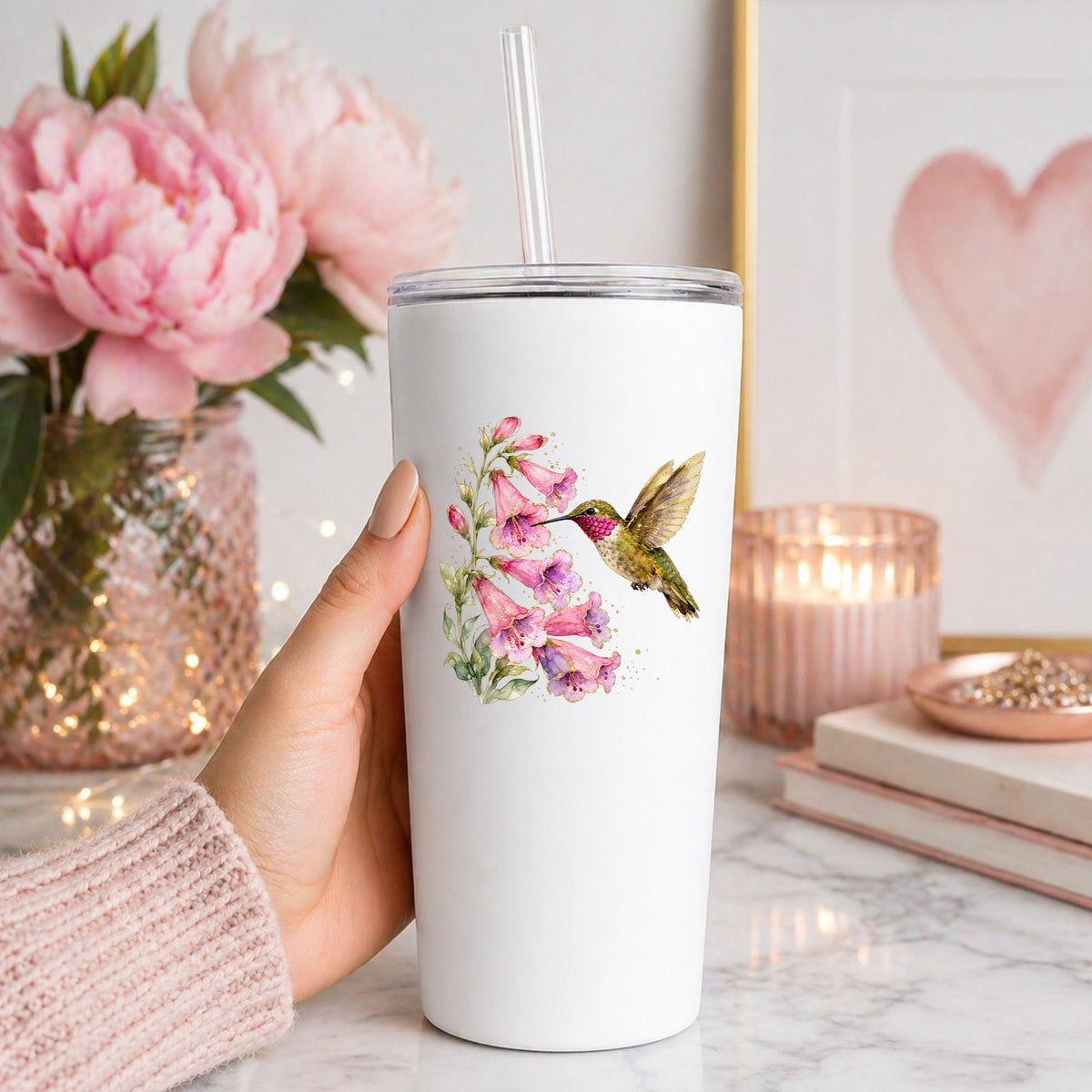 Ruby Throated Hummingbird Pink Bells UV DTF sticker applied to a white straw tumbler beside pink peonies