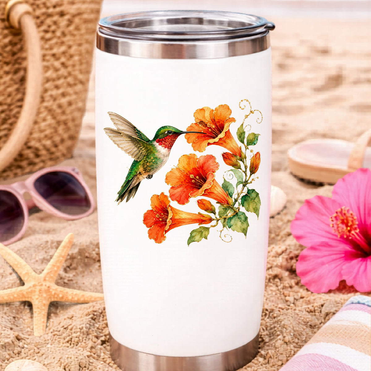 Red Throat Hummingbird Trumpet Flowers UV DTF sticker applied to a white travel tumbler on beach sand