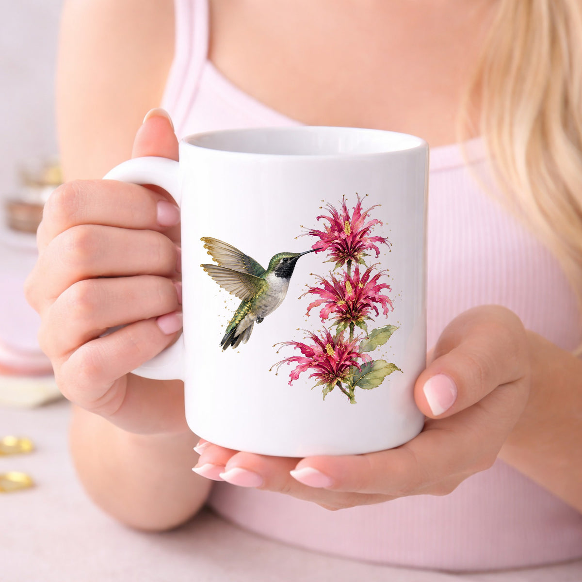 Hummingbird Pink Bee Balm UV DTF sticker applied to a white coffee mug held in both hands
