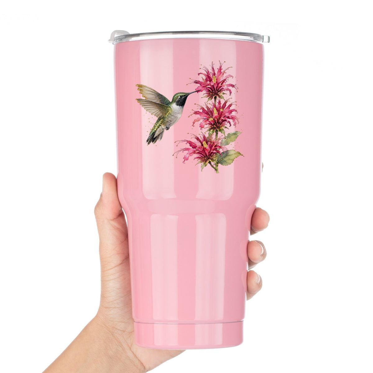 Hummingbird Pink Bee Balm UV DTF sticker applied to a pink tumbler held against a white background
