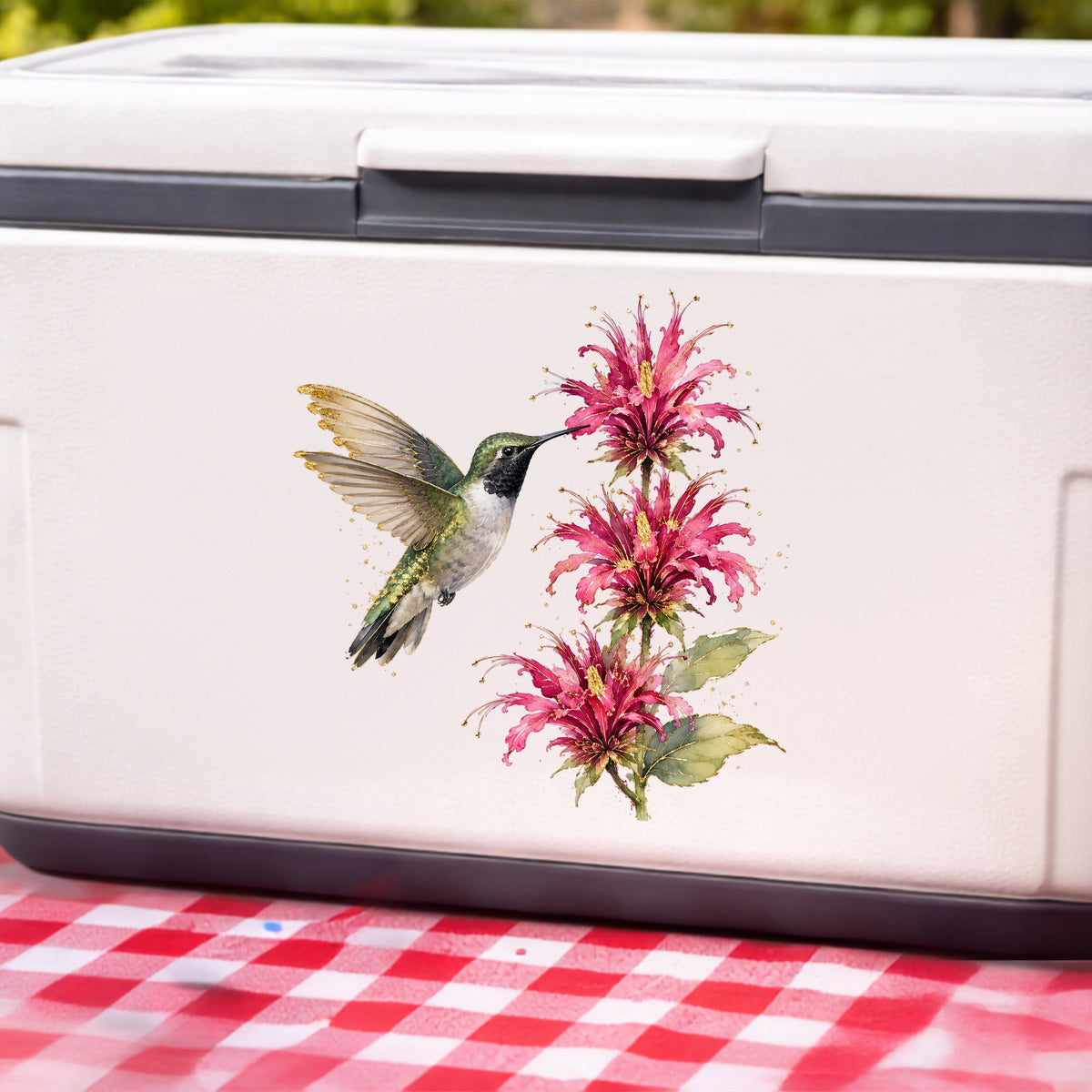Hummingbird Pink Bee Balm UV DTF sticker applied to a white cooler on a red gingham cloth
