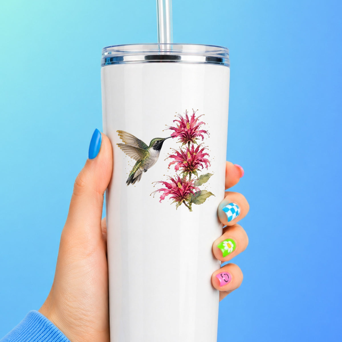 Hummingbird Pink Bee Balm UV DTF sticker applied to a white straw tumbler on a blue background