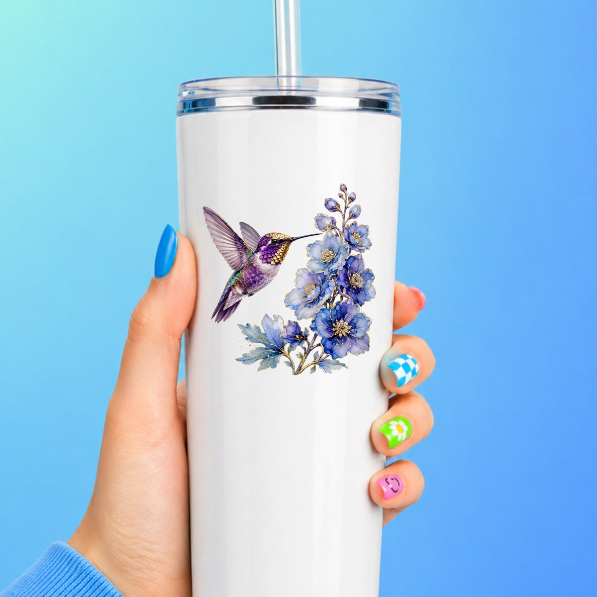 Purple Hummingbird Blue Delphinium UV DTF sticker applied to a white straw tumbler on a blue background