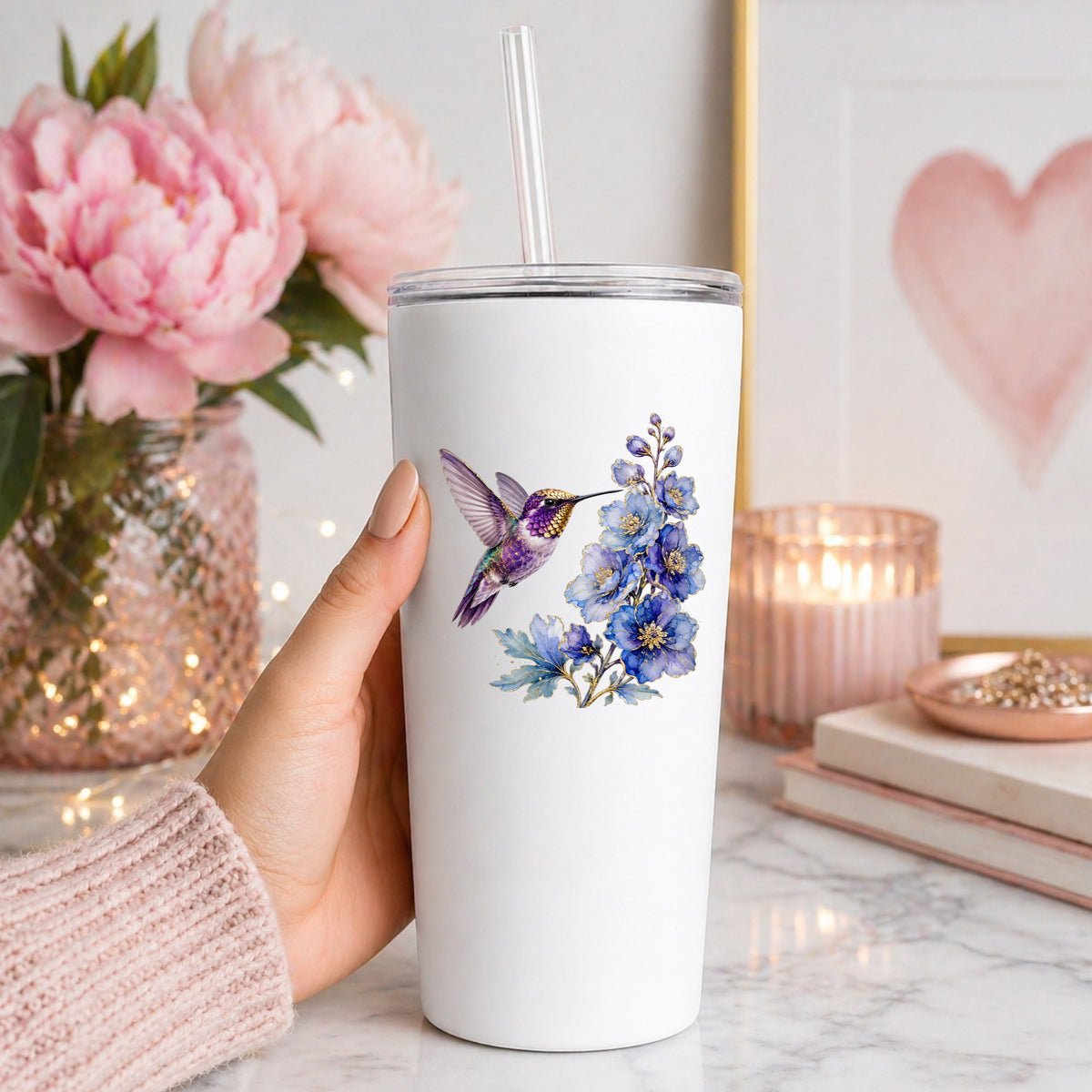 Purple Hummingbird Blue Delphinium UV DTF sticker applied to a white straw tumbler beside pink peonies