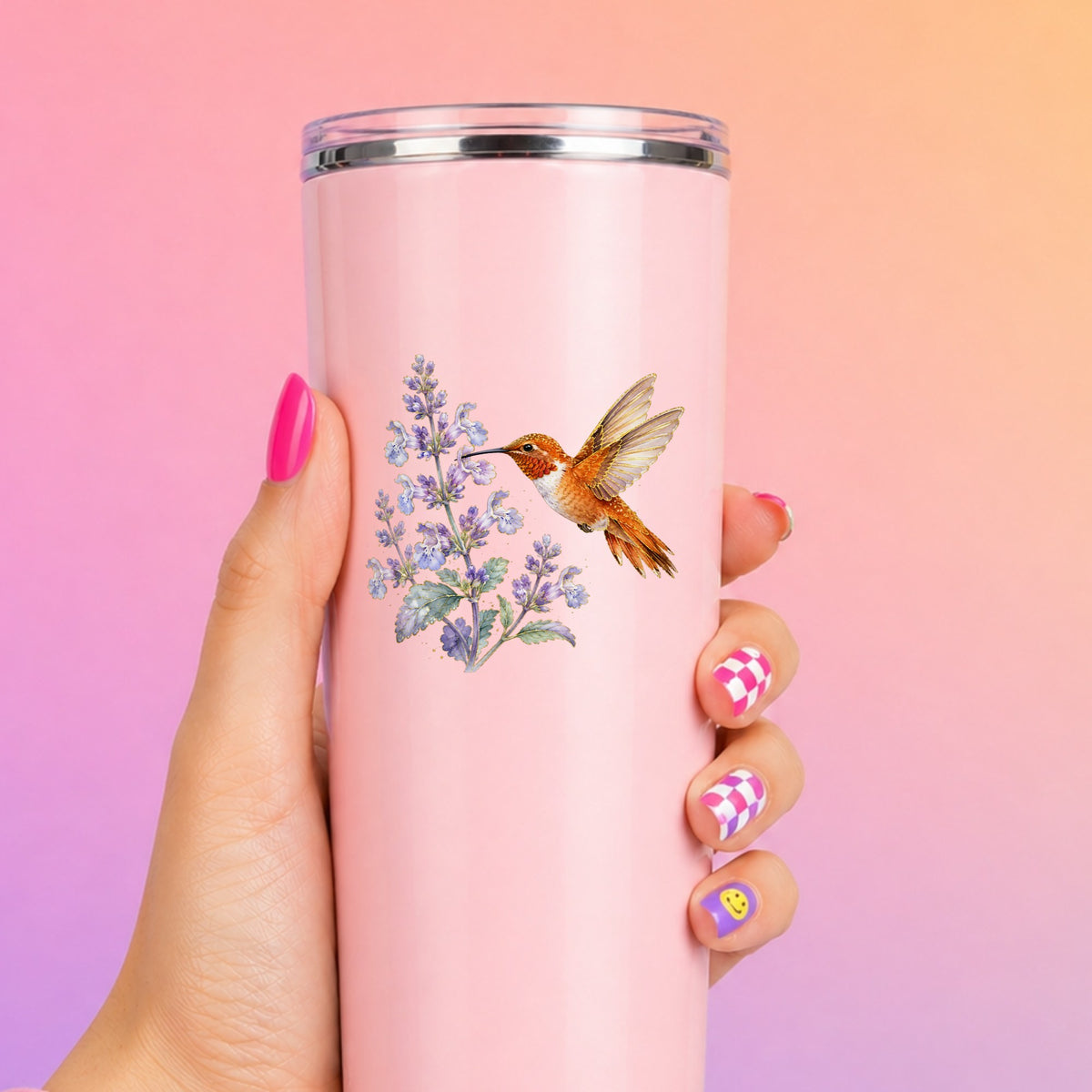 Rufous Hummingbird Lavender UV DTF sticker applied to a tall pink tumbler on a pink and orange background