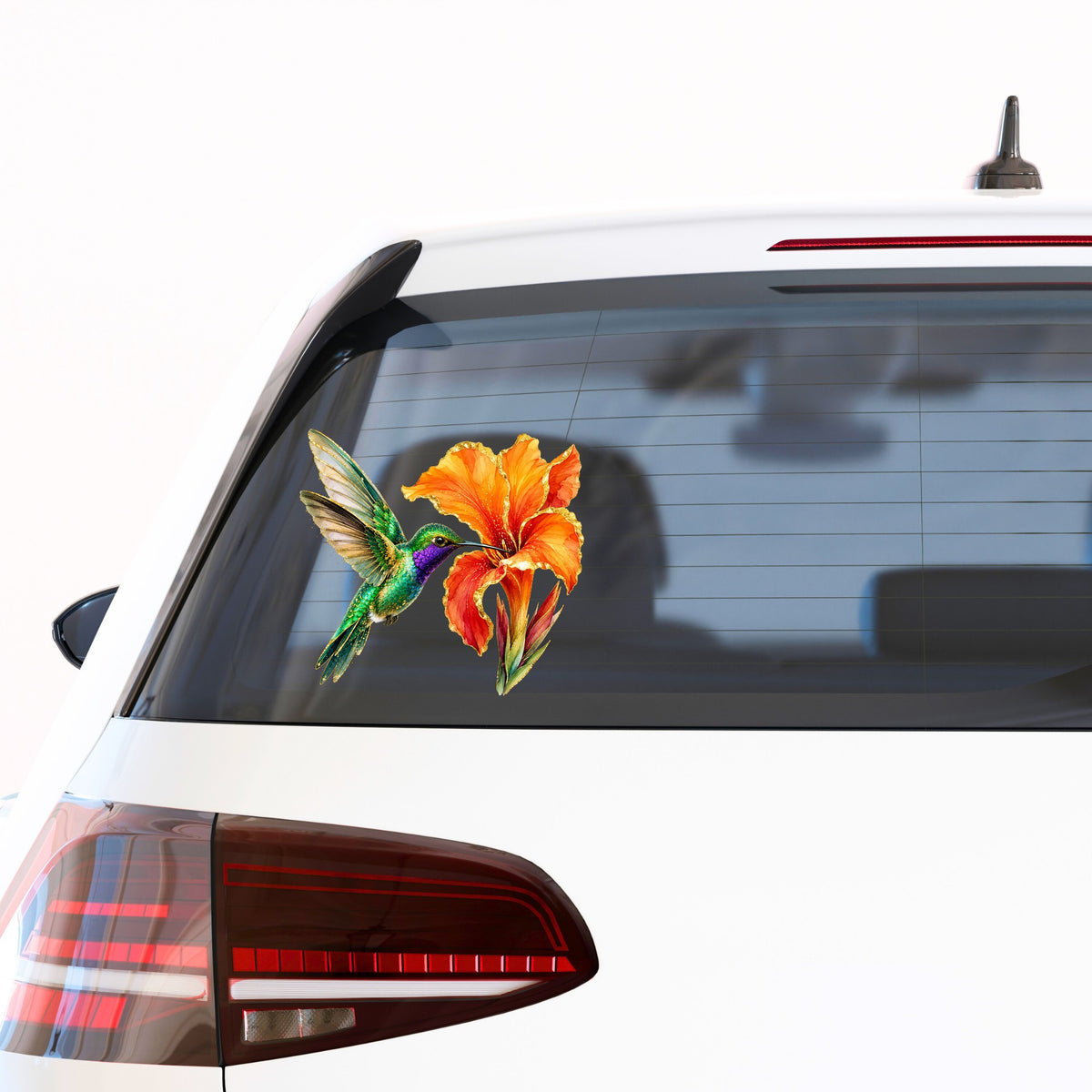 Hummingbird Orange Canna Lily UV DTF sticker applied to the rear window of a white car