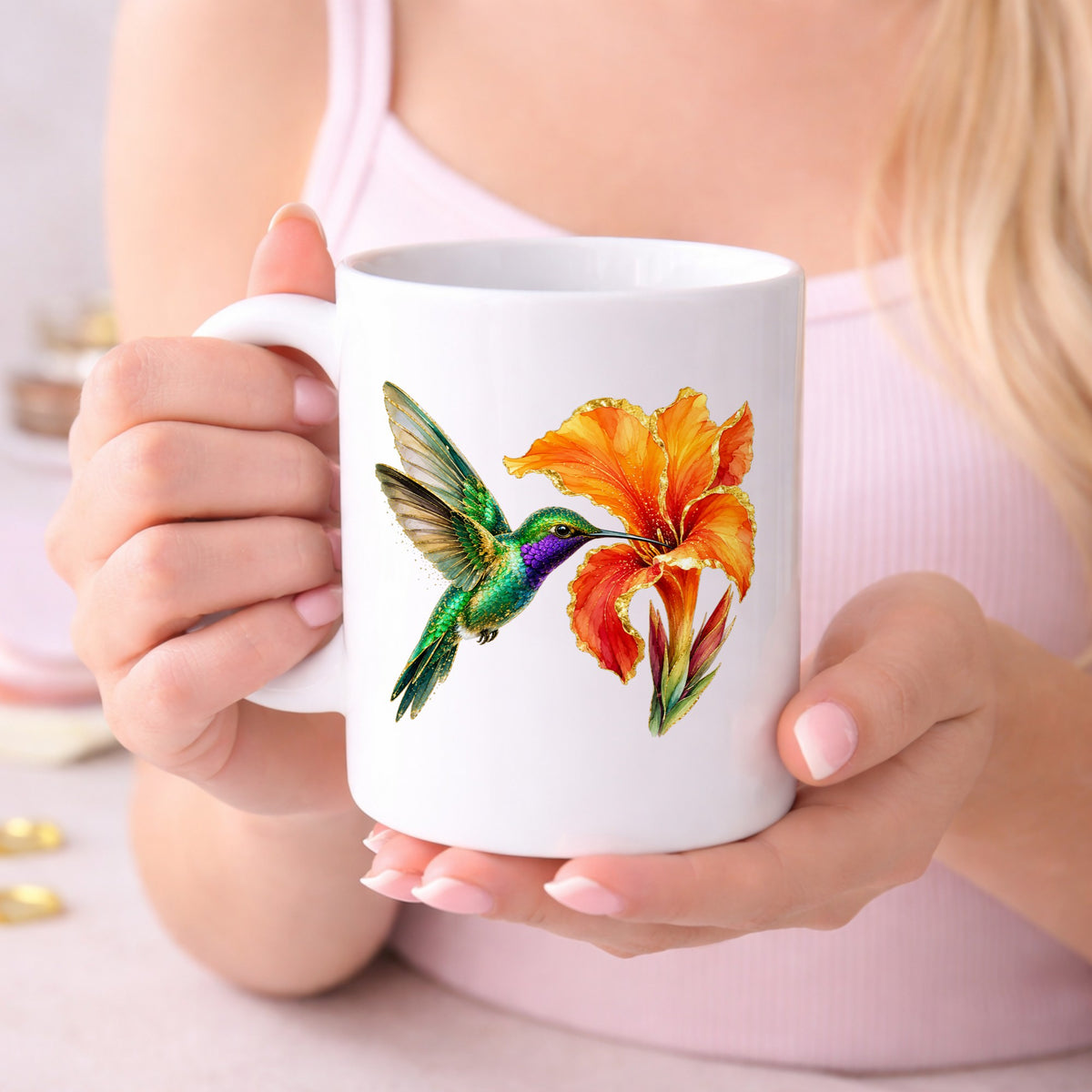 Hummingbird Orange Canna Lily UV DTF sticker applied to a white coffee mug held in both hands