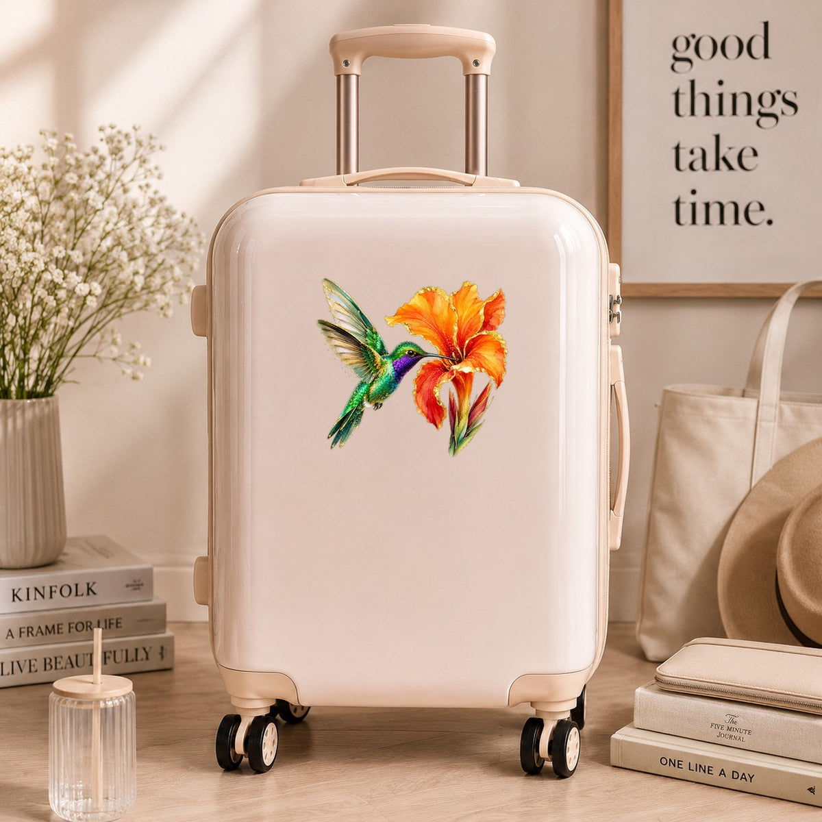 Hummingbird Orange Canna Lily UV DTF sticker applied to a cream carry-on suitcase