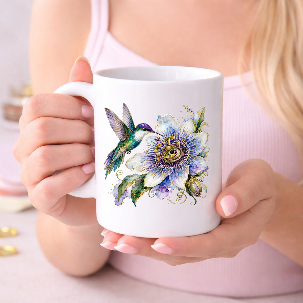 Hummingbird Passion Flower UV DTF sticker applied to a white coffee mug held in both hands