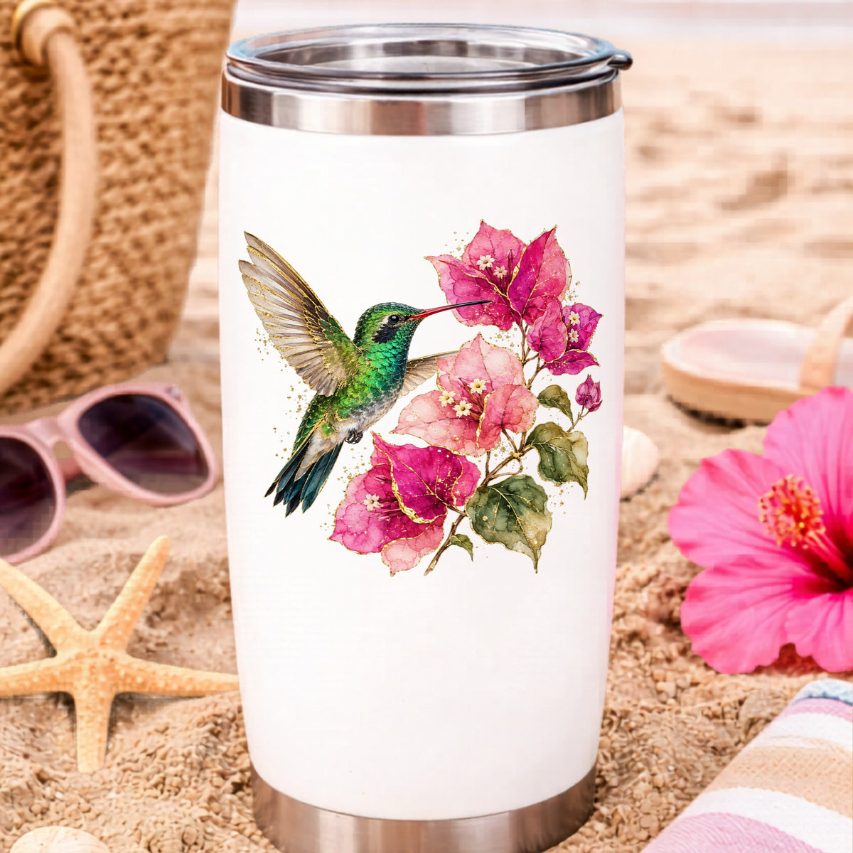 Hummingbird Pink Bougainvillea UV DTF sticker applied to a white travel tumbler on beach sand