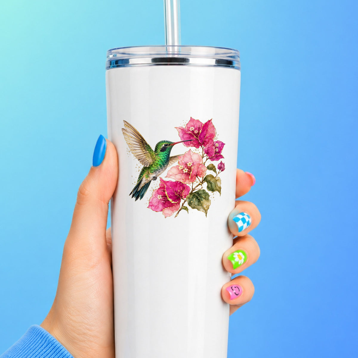 Hummingbird Pink Bougainvillea UV DTF sticker applied to a white straw tumbler on a blue background