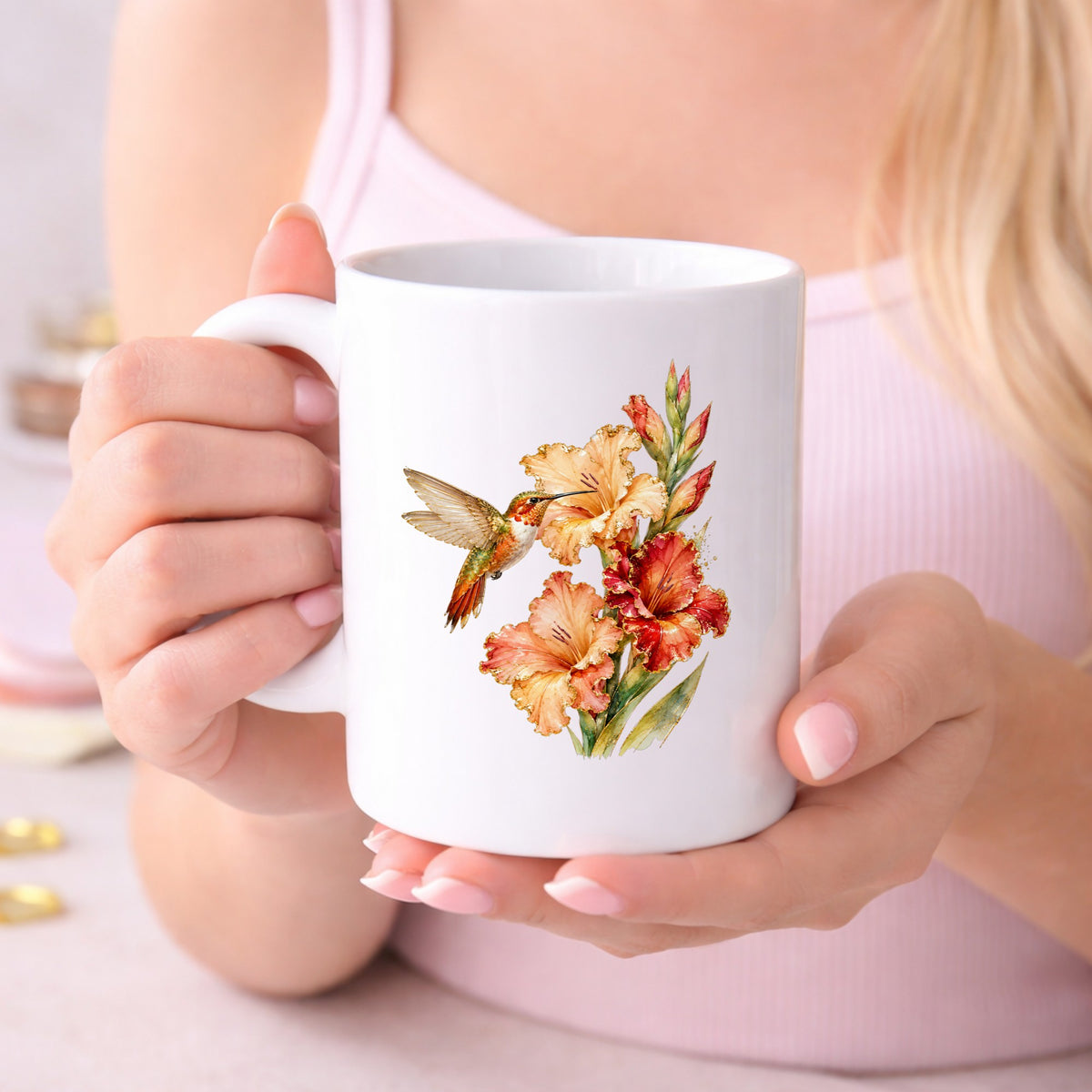 Hummingbird Peach Gladiolus UV DTF sticker applied to a white coffee mug held in both hands