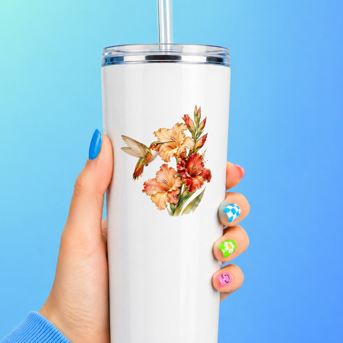 Hummingbird Peach Gladiolus UV DTF sticker applied to a white straw tumbler on a blue background
