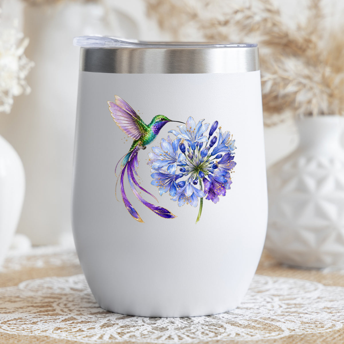 Hummingbird Blue Agapanthus UV DTF sticker applied to a white stemless tumbler with a lid