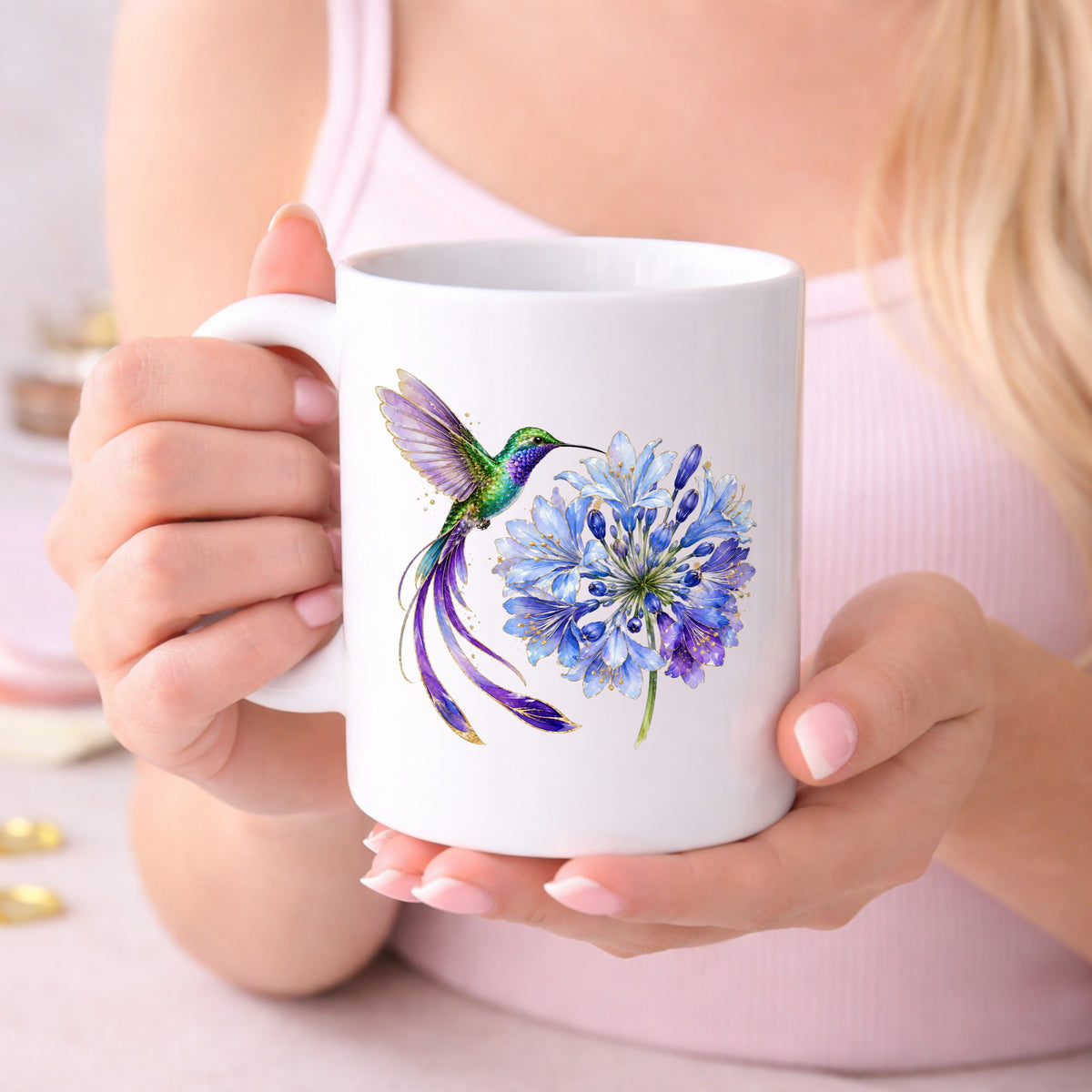 Hummingbird Blue Agapanthus UV DTF sticker applied to a white coffee mug held in both hands