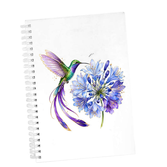 Hummingbird Blue Agapanthus UV DTF sticker applied to the cover of a white spiral journal
