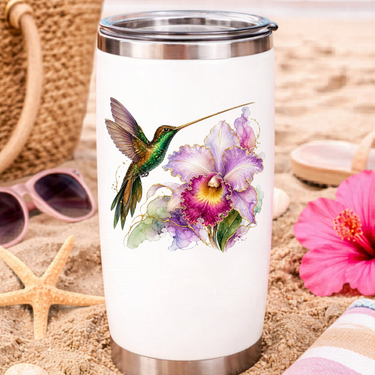 Hummingbird Purple Orchid UV DTF sticker applied to a white travel tumbler on beach sand