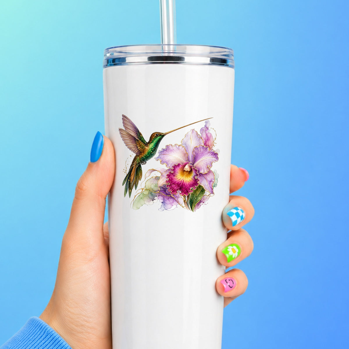 Hummingbird Purple Orchid UV DTF sticker applied to a white straw tumbler on a blue background