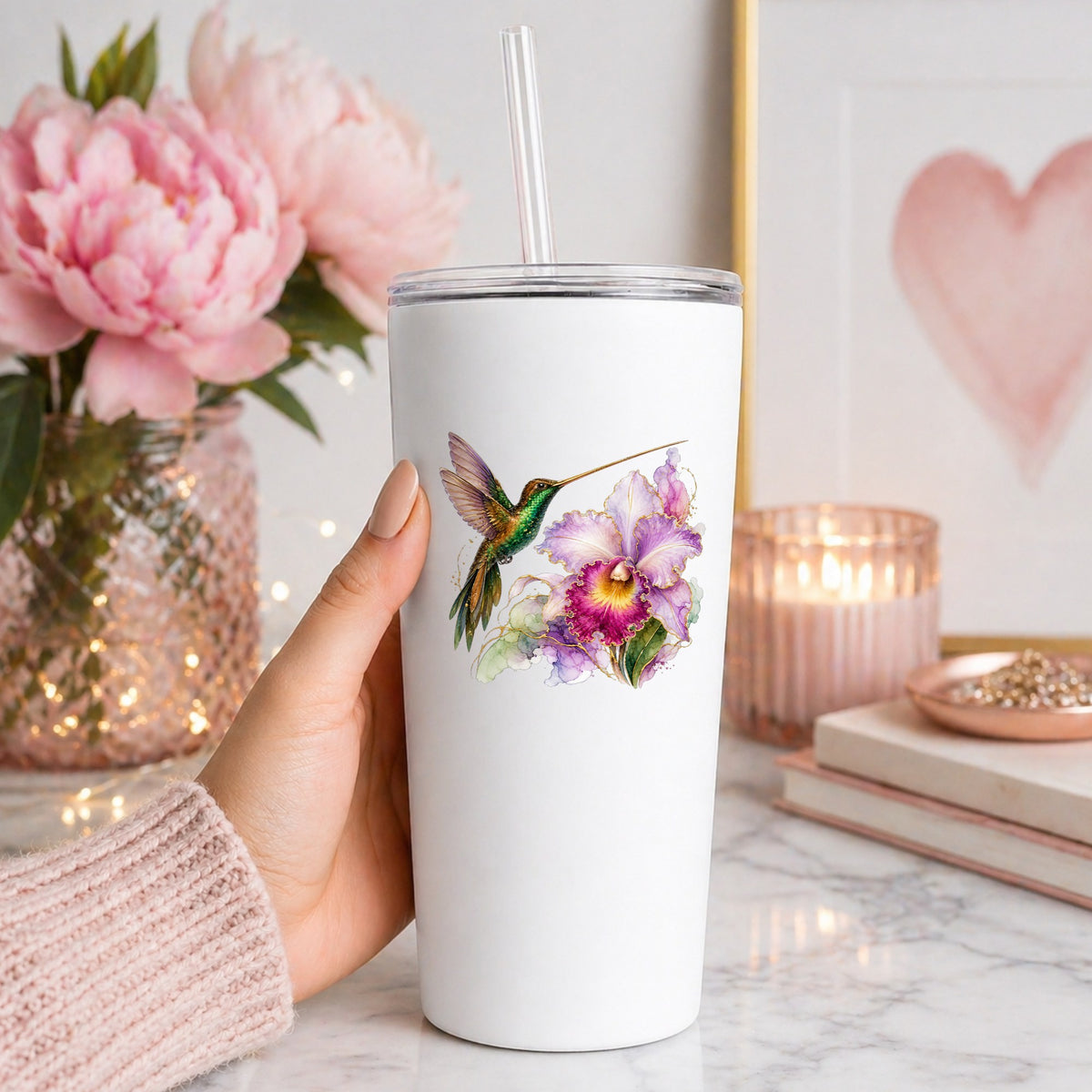 Hummingbird Purple Orchid UV DTF sticker applied to a white straw tumbler beside pink peonies
