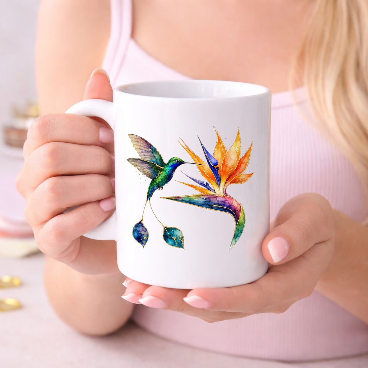 Hummingbird Bird Of Paradise Flower UV DTF sticker applied to a white coffee mug held in both hands