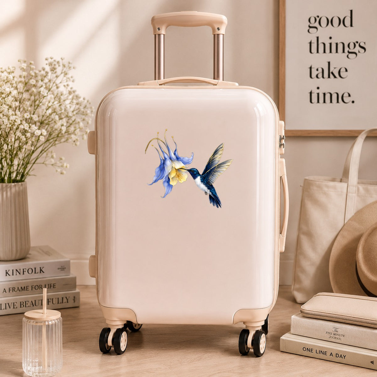 Navy Hummingbird Blue Columbine UV DTF sticker applied to a cream carry-on suitcase