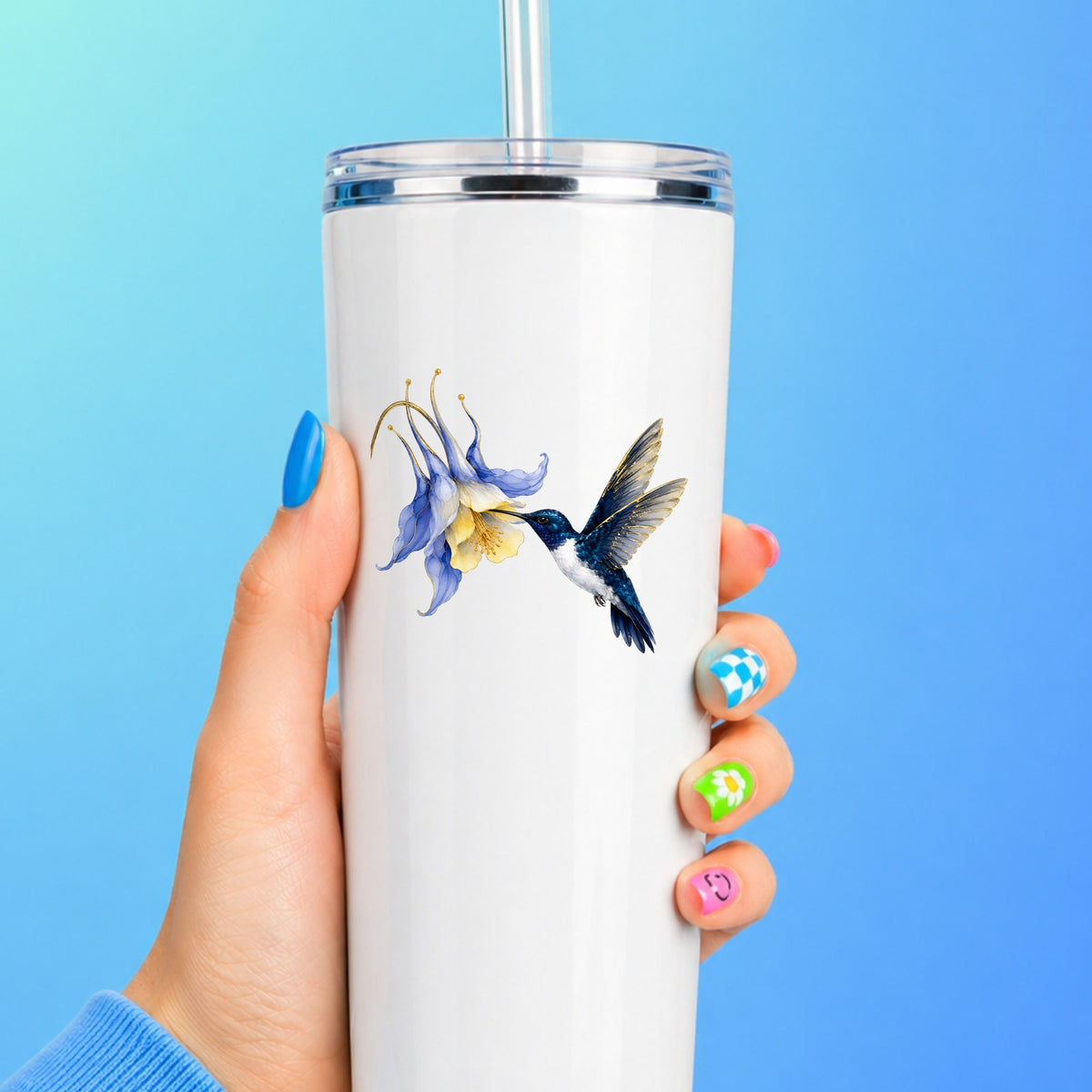 Navy Hummingbird Blue Columbine UV DTF sticker applied to a white straw tumbler on a blue background