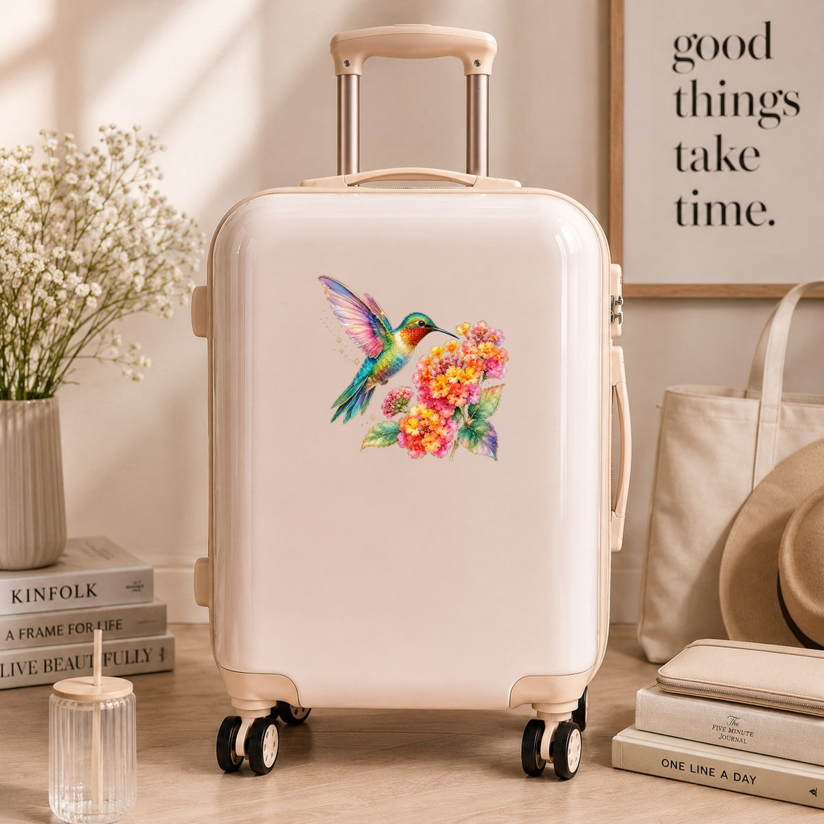 Rainbow Hummingbird Lantana UV DTF sticker applied to a cream carry-on suitcase