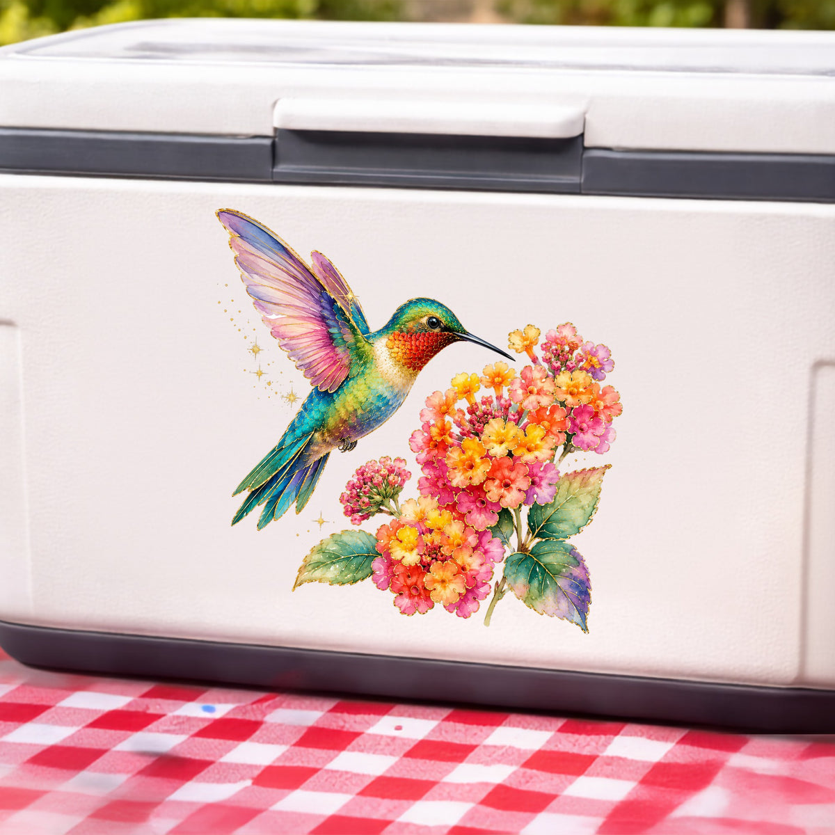 Rainbow Hummingbird Lantana UV DTF sticker applied to a white cooler on a red gingham cloth