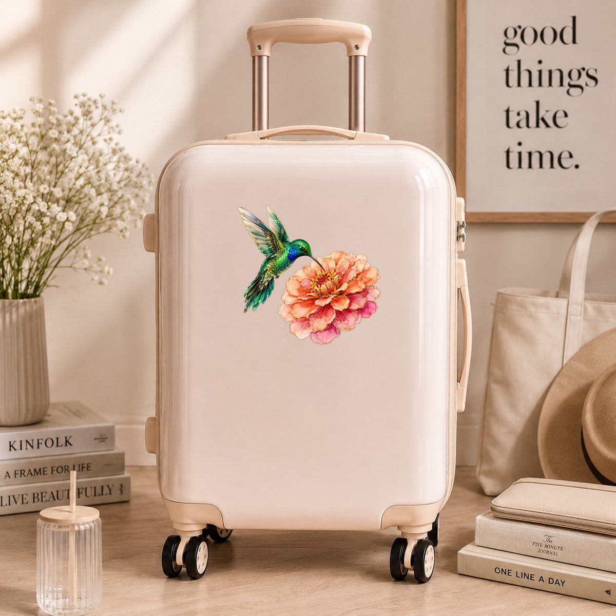 Hummingbird Coral Zinnia UV DTF sticker applied to a cream carry-on suitcase