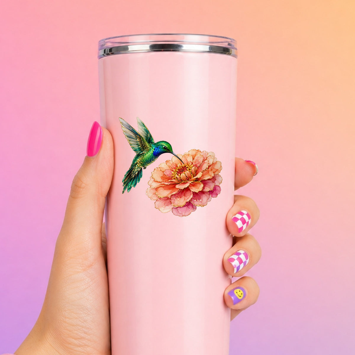 Hummingbird Coral Zinnia UV DTF sticker applied to a tall pink tumbler on a pink and orange background