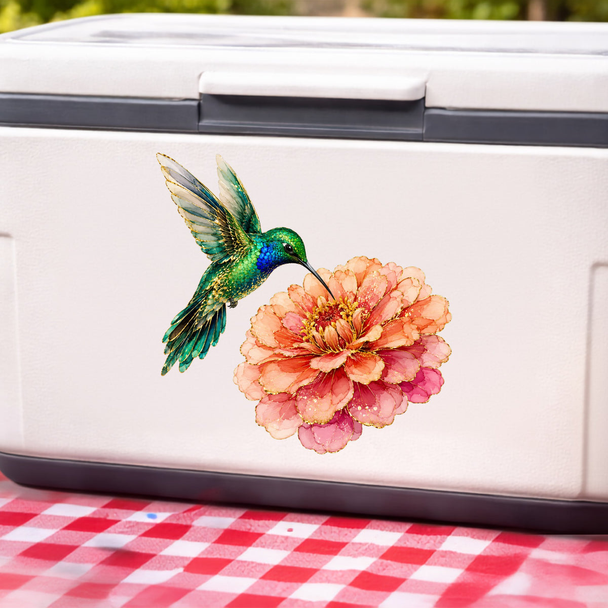 Hummingbird Coral Zinnia UV DTF sticker applied to a white cooler on a red gingham cloth