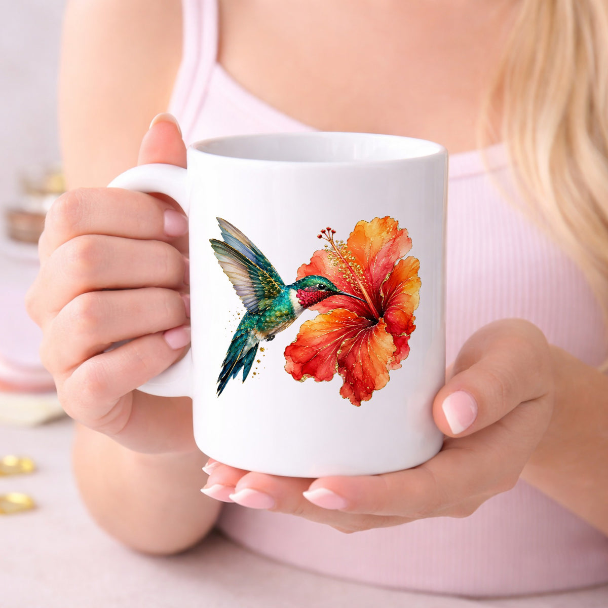 Hummingbird Red Hibiscus UV DTF sticker applied to a white coffee mug held in both hands