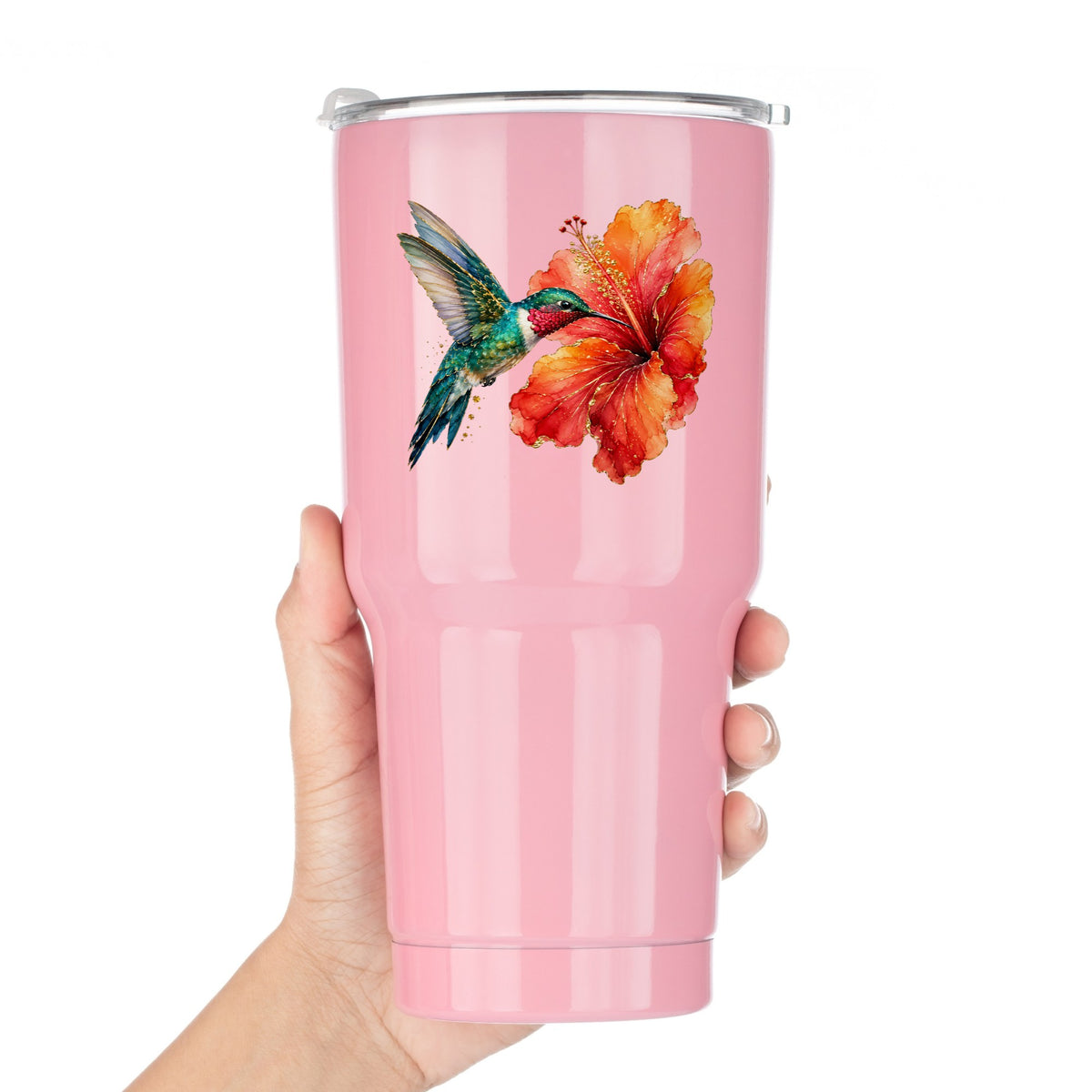 Hummingbird Red Hibiscus UV DTF sticker applied to a pink tumbler held against a white background