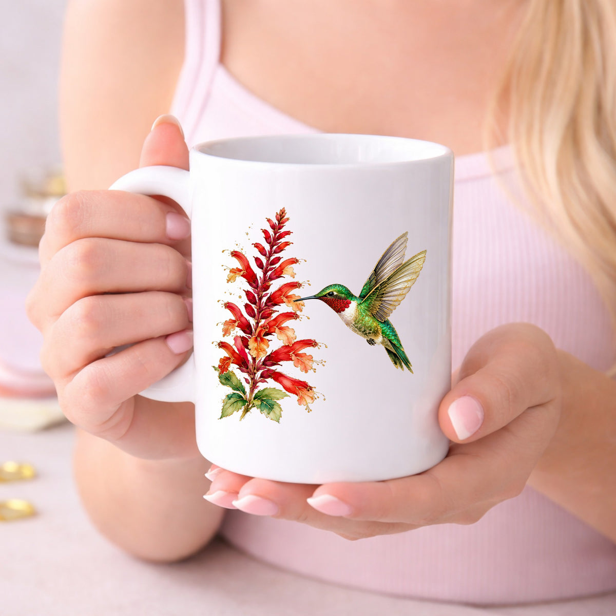 Hummingbird Red Salvia UV DTF sticker applied to a white coffee mug held in both hands