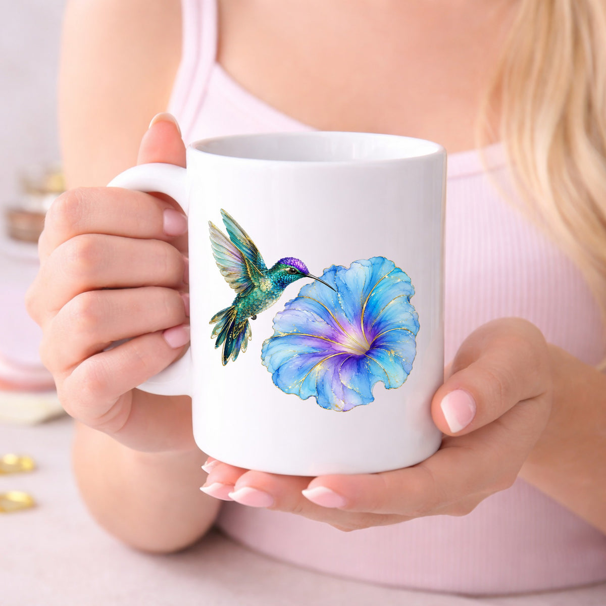 Teal Hummingbird Blue Morning Glory UV DTF sticker applied to a white coffee mug held in both hands