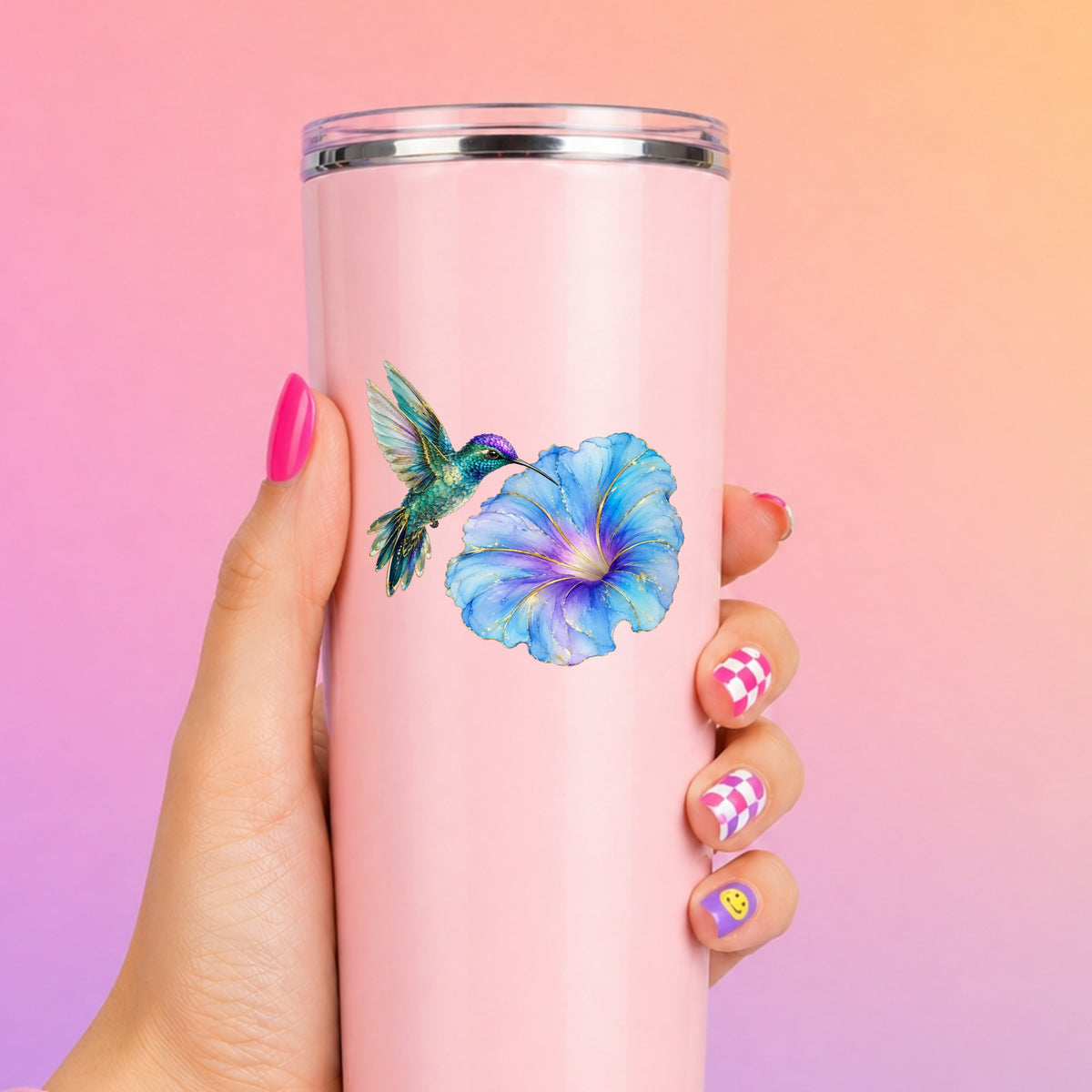 Teal Hummingbird Blue Morning Glory UV DTF sticker applied to a tall pink tumbler on a pink and orange background