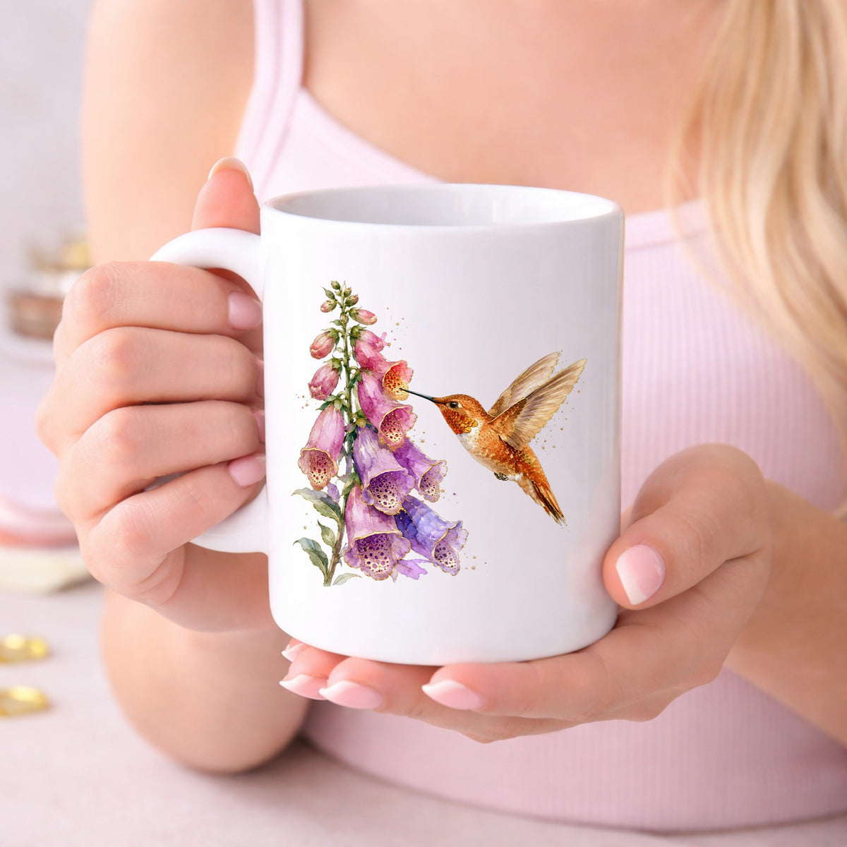 Rufous Hummingbird Pink Foxglove UV DTF sticker applied to a white coffee mug held in both hands