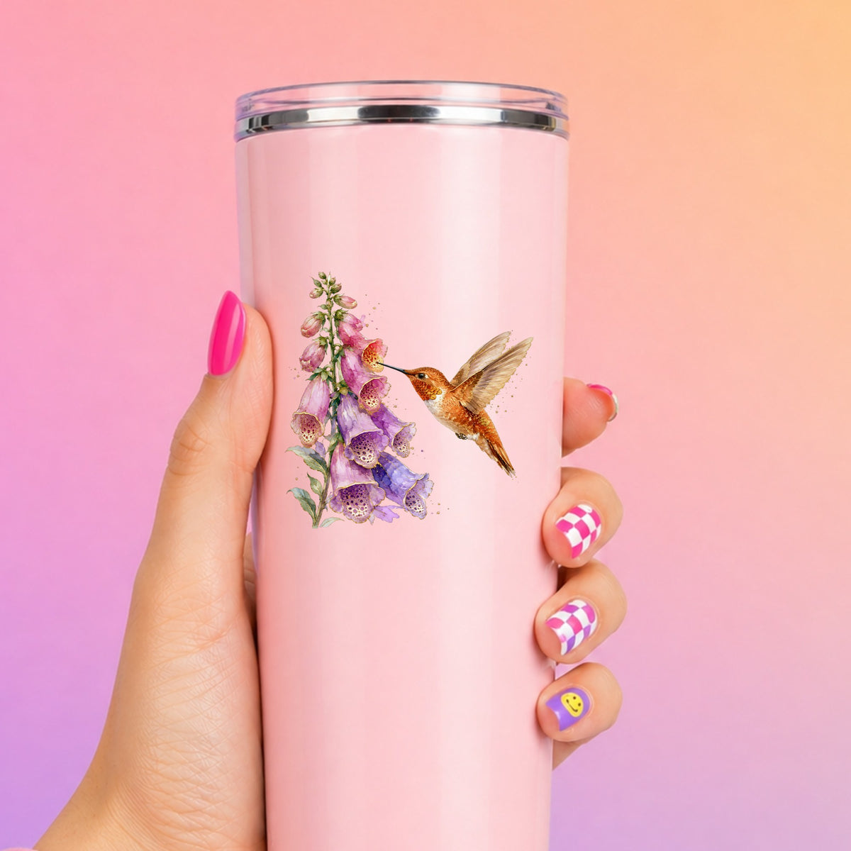 Rufous Hummingbird Pink Foxglove UV DTF sticker applied to a tall pink tumbler on a pink and orange background